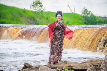 Wall Mural - Woman on the waterfalls. Little waterfall. Camping. . Young woman. Woman in a dress.