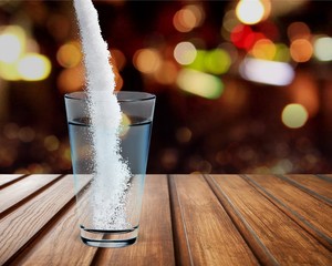 Pouring powder on water glass on  background