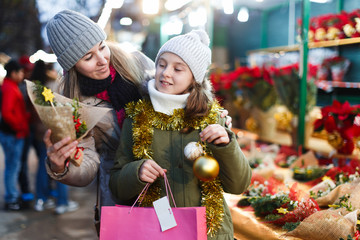 Wall Mural - Woman and her daughter are preparing for Christmas and choosing gifts for their family