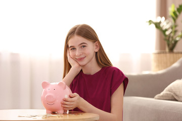 Poster - Teen girl with piggy bank and money at home