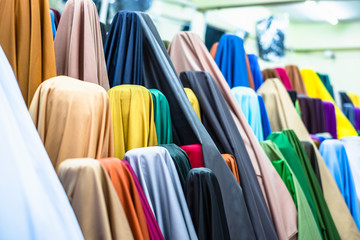 Colorful of many fabric rolls selling in market stall shop. Fashion desig concept.