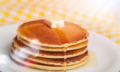 Sticker - Stack of Small pancakes in syrup on background