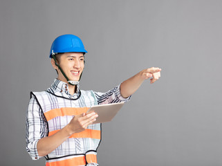 Wall Mural - smiling asian young man construction worker