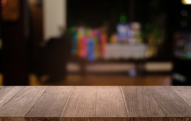 Empty dark wooden table in front of abstract blurred bokeh background of restaurant . can be used for display or montage your products.Mock up for space.