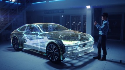 Fototapete - Automotive Engineer Working on Electric Car Chassis Platform, Using Tablet Computer with Augmented Reality 3D Software. Innovative Facility: Vehicle Frame with Wheels Becomes a Solid Virtual Model.