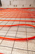 © schankz - Installing a hose for underfloor heating in the room