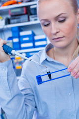 Poster - Female technician in laboratory of genetics - reprogenetics. Young technician use dispenser for pipetting PCR strips