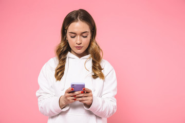 Sticker - Calm blonde woman wearing in casual clothes using smartphone