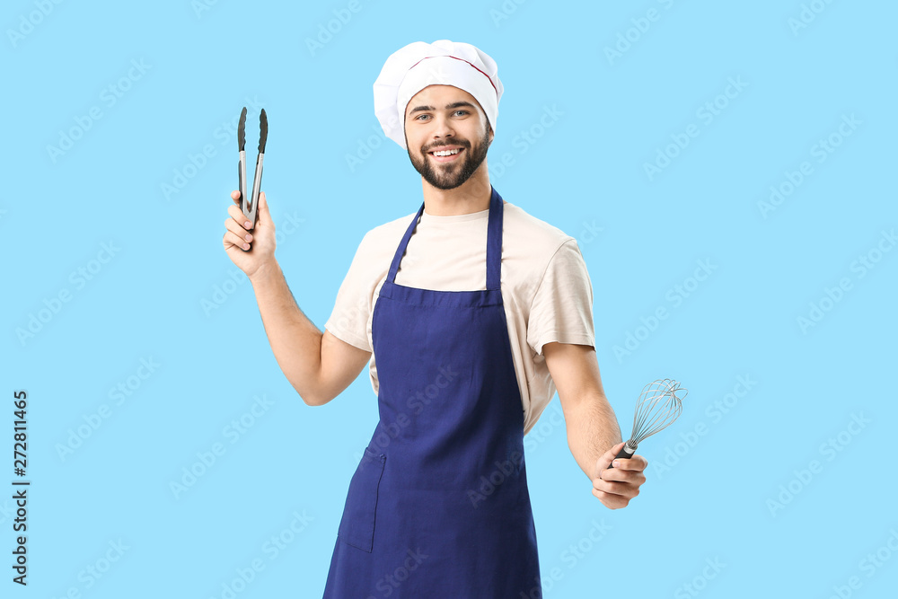 Handsome male chef on color background