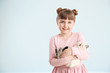 © Pixel-Shot - Girl with cute fluffy kitten on light background
