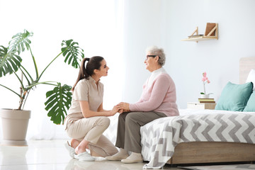 Canvas Print - Caregiver with senior woman in nursing home