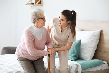 Wall Mural - Caregiver with senior woman in nursing home