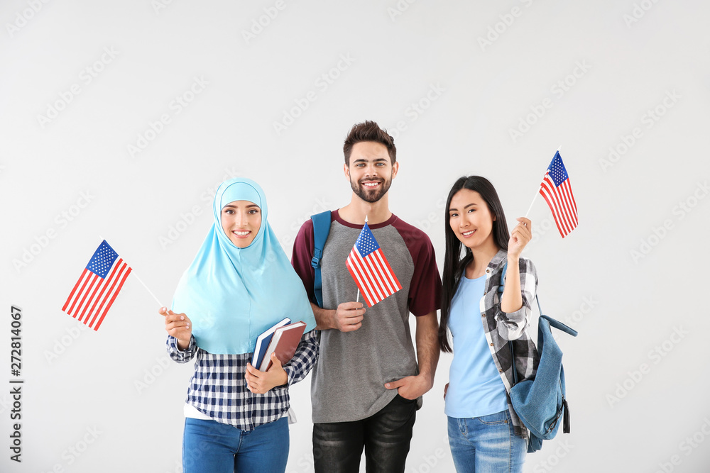 Group of students with USA flags on light background