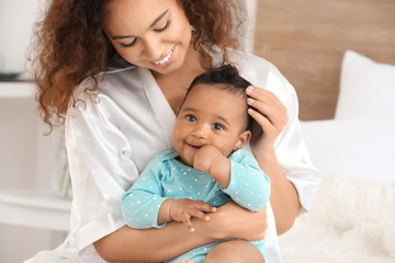 Canvas Print - Happy African-American mother with cute little baby in bedroom