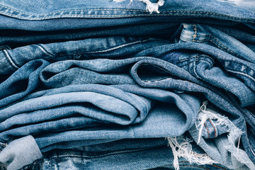 Stack of jeans on table. Zero vaste concept. Ecology and recycling.