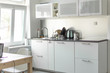 Kitchen modern interior. White kitchen furniture. Working at home- freelance concept.