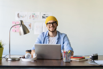 Wall Mural - Enjoying his work. Skilled male IT professional freelancer working on clients project, using laptop computer and wireless internet.