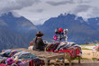 Peruvian women selling colorful hats and scarfs on the scenic and popular viewpoint.