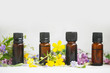 Aromatherapy herbal essential oil bottles with plants and flowers
