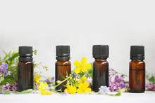 Aromatherapy Herbal Essential Oil Bottles With Plants And Flowers