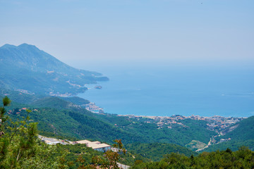 view of the city on the seashore, on the water traces of yachts, blue sea on a clear day.