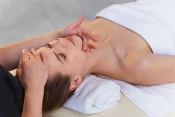 Wall Mural - Young masseur making massage for young female client.