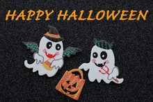 Two White Bat Ghosts With Hats And Pitch Fork One Holding A Candy Bag On A Black Background With Happy Halloween In Orange Text
