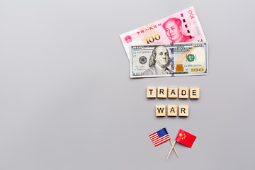 Creative top view flat lay of China and USA flags and cash money, mockup and copy space on gray background in minimal style. Concept of trade war between USA and China