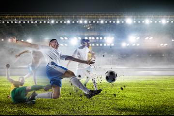 Wall Mural - Soccer players on stadium in action. Mixed media