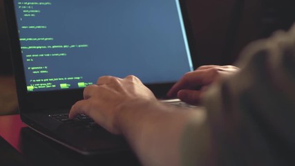 Close up hands developing software app using digital laptop computer typing and coding code on laptop screen