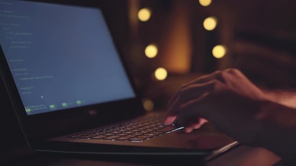 Close up hands developing software app using digital laptop computer typing and coding code on laptop screen