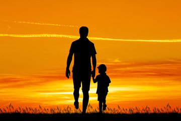 Wall Mural - father and son walk at sunset