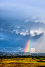 Dramatic Storm Clouds And A Rainbow Over The Oroville Dam And The Foothills In The Background.