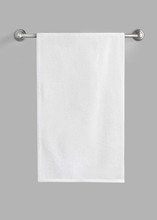 White Cotton Terry Towel Hanging On The Rail Isolated. White Towel Against The Gray Background.