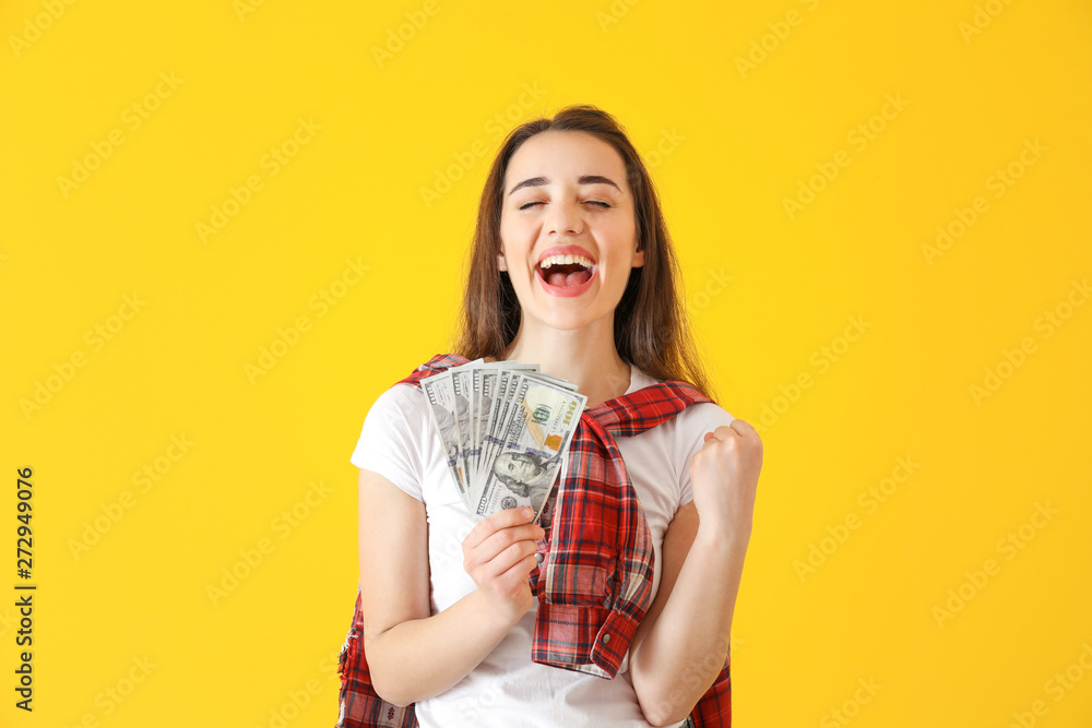 Happy young woman with dollar banknotes on color background