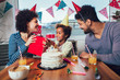 © Mediteraneo - Happy family celebrating a birthday together at home