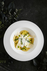 Wall Mural - White Restaurant Plate of Ravioli 4 Cheeses with Cheese Espoume Top View