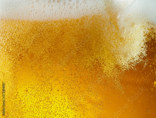 Close up view of floating bubbles in light golden colored beer background Poster Mural XXL