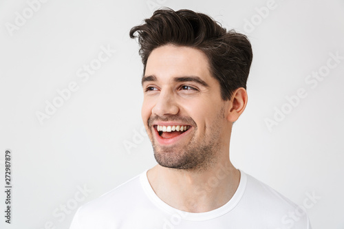 Fotomural Happy young excited emotional man posing isolated over white wall background