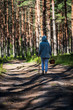 © Martins Vanags - young woman looking for berries and mushrooms in forest