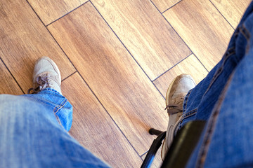 The guy is sitting at the bar on a high chair. Close-up photo, top view, selective focus.