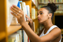Black African American Young Girl Student Studying At The School University Library