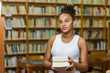 © Samuel B. - Black african american young girl student studying at the school university library