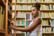 © Samuel B. - Black african american young girl student studying at the school university library