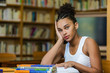 © Samuel B. - Black african american young girl student studying at the school university library