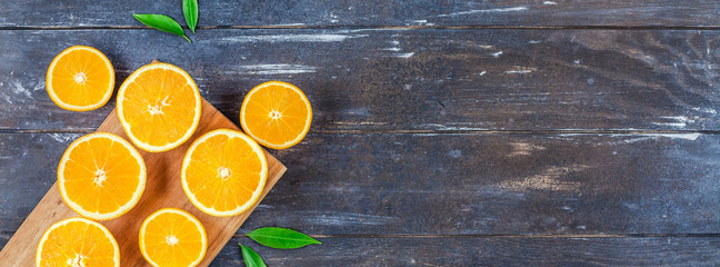 Wall Mural - Fresh oranges on dark wooden background