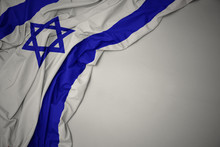 Waving National Flag Of Israel On A Gray Background.