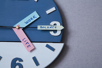Work life balance choice concept. Clock closeup and arrows telling