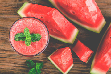 Canvas Print - A glass of fresh watermelon juice on a wooden board background