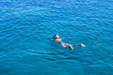 Fototapeta Do akwarium - swimming and snorkeling sexy girl aerial summer vacation photography style wallpaper pattern with empty copy space for text